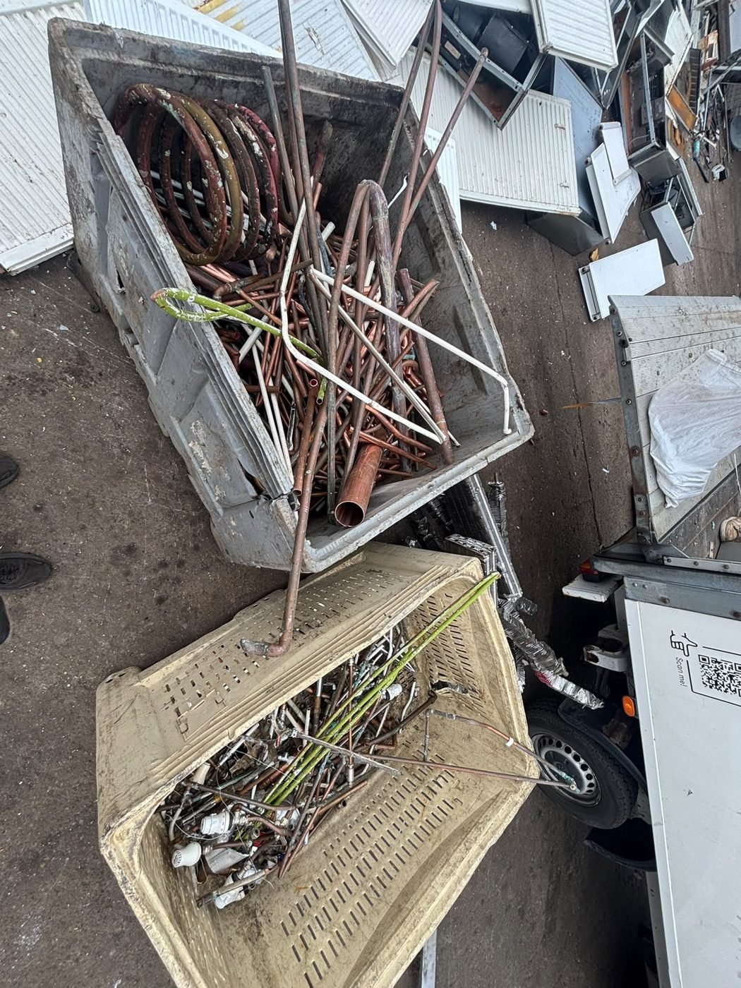 Mixed scrap and copper pipes in collection bins