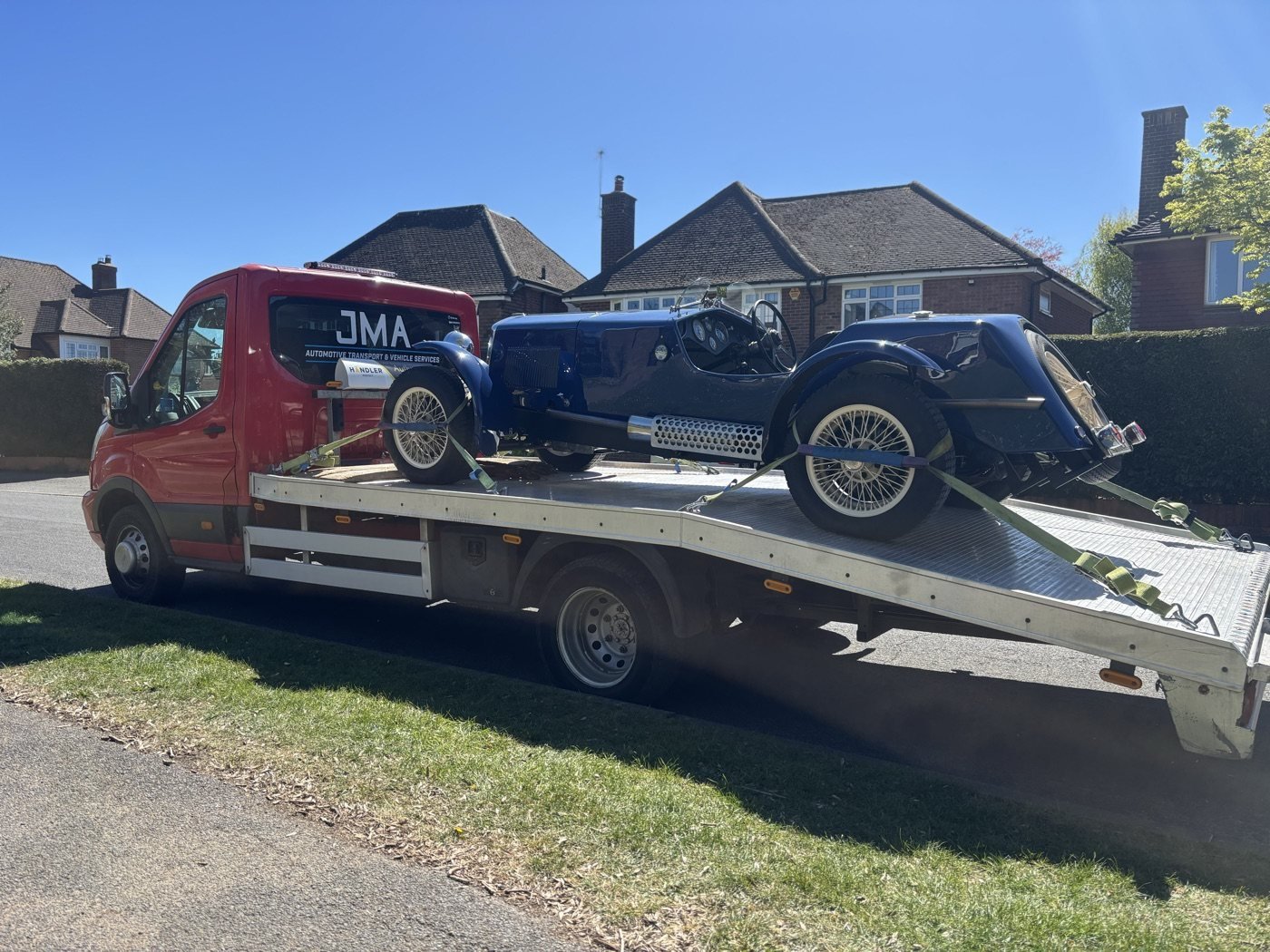 Classic blue car on a JMA recovery truck