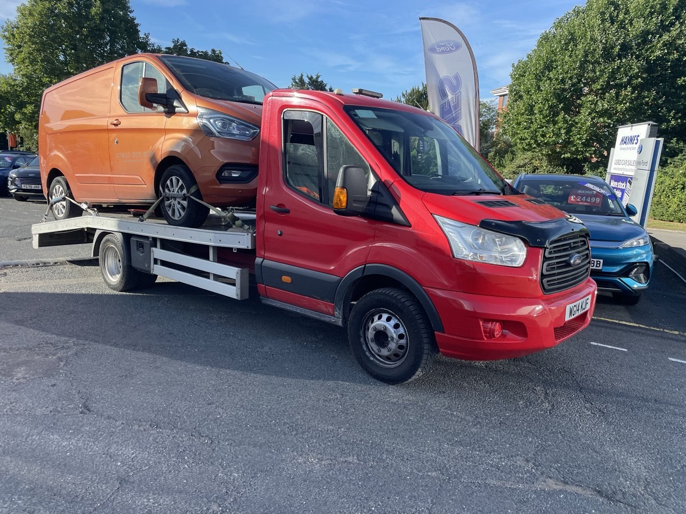 Orange van carried by a JMA recovery truck