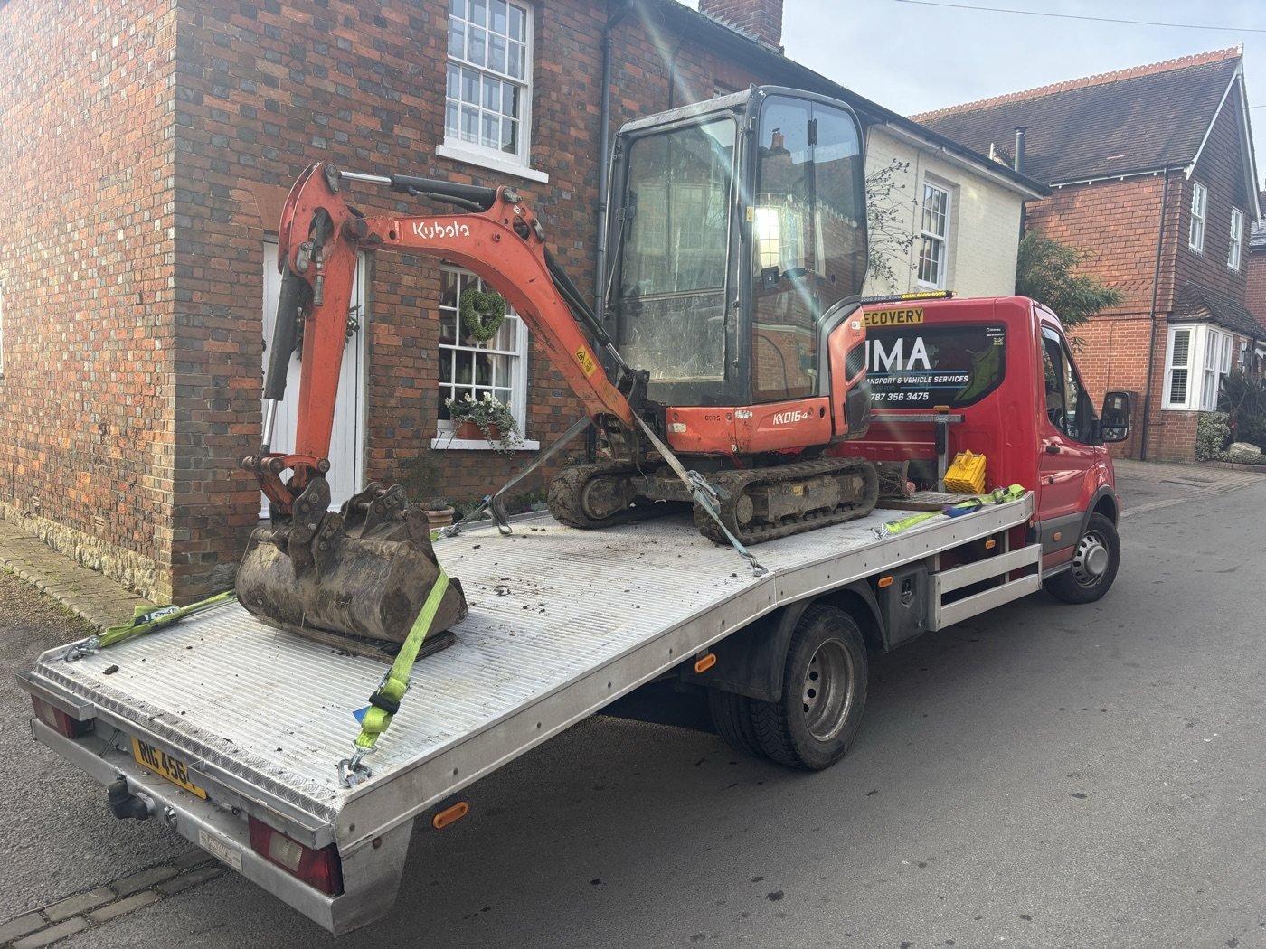 Mini excavator on a JMA recovery truck