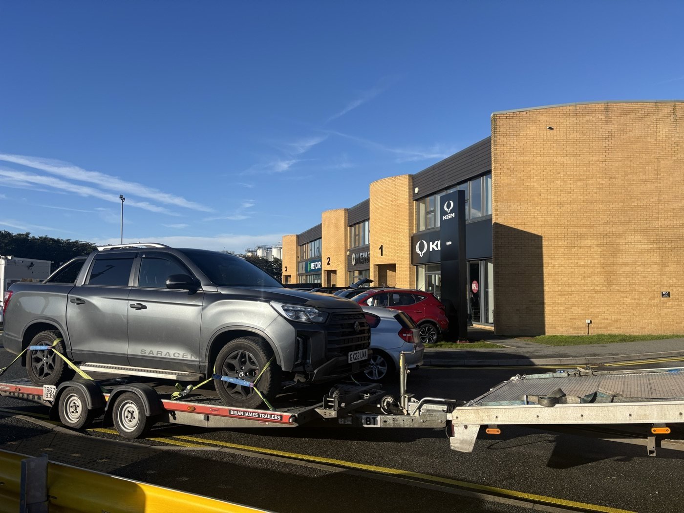 Pickup secured on a vehicle trailer