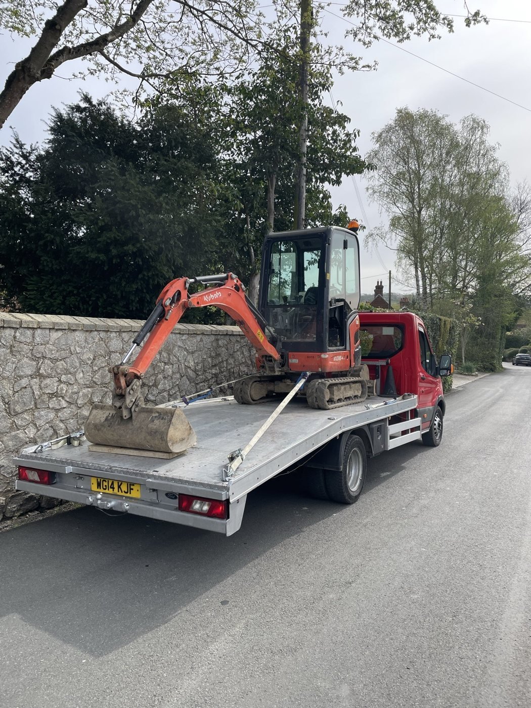 Excavator carried on a JMA recovery truck