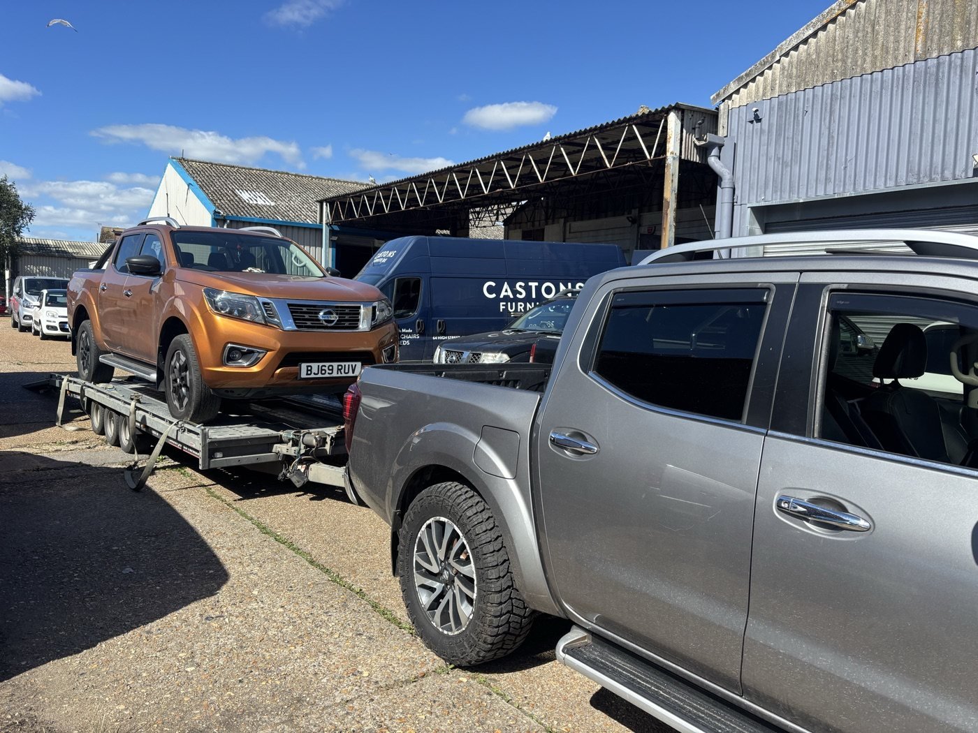 Orange pickup transported on a trailer